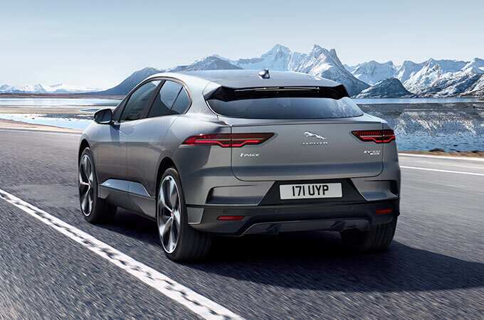 Rear view of Jaguar I-PACE driving along a mountain road.