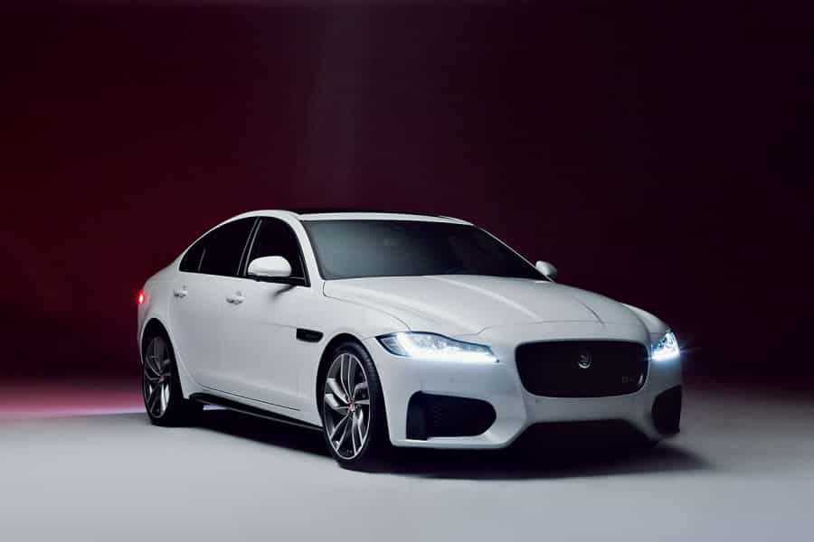 Jaguar XF in white front side view.