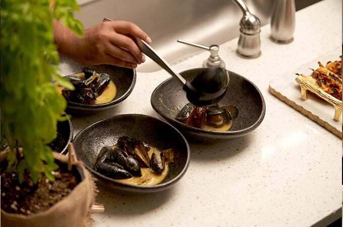 Chef Aakash Trivedi prepares a bowl of mussels.