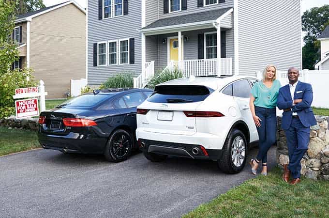 Kara and John with their Jaguar vehicles.