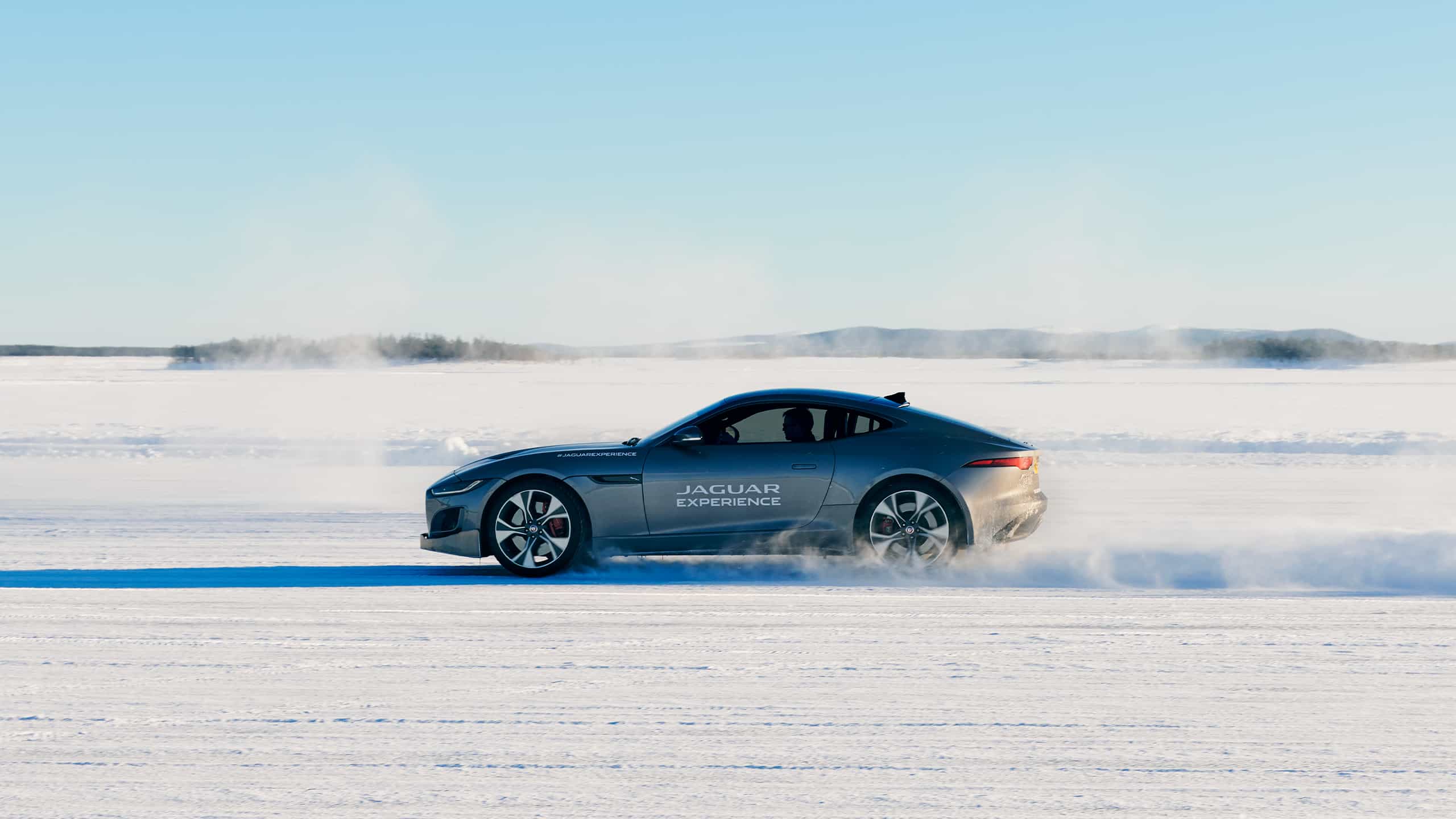 Jaguar FTYPE passes through a snowdrift and snowy land road